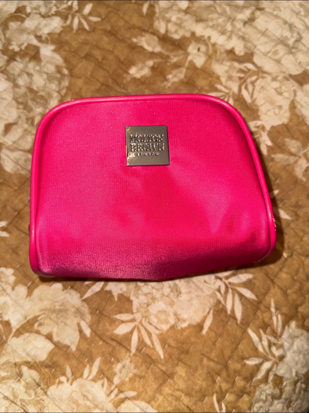 Hot pink Molton brown zip up makeup case.